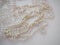White beads. Decorative decoration. Women's jewelry. Beautiful shiny bright beads. Fashion background. Collage and