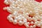 White beads on a red background