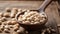 White beans in a spoon on a wooden background.