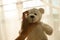 White bear doll strangled by woman hand in morning light domestic violence victim concept