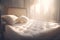 a white bed with two pillows and a pillow on it\\\'s headboard in a room with sunlight streaming throug