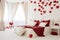 White bedroom decorated with red hearts.