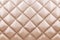 White beige velvet capitone textile background, retro Chesterfield style checkered soft tufted fabric furniture diamond pattern d