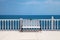 White bench, balustrade and sea