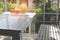 white bench and table beside glass door with garden view