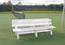 White bench on a tennis court