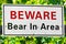 A white beware bear in area sign