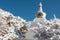 White Bhuddist stupa in snow in Himalayas