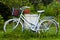 White bicycle or bike as garden decoration