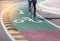 White bicycle lane sign and arrow on green asphalt road