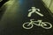 White bicycle and the man symbols on the wet pavement asphalt