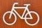 White bicycle sign on a corten steel rusted background