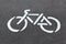 White bicycle sign on a road closeup
