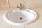 White bidet with a bronze faucet