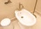 White bidet with a bronze faucet