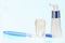 White big health tooth, toothbrush and toothpaste for dental care, on light blue dental background.