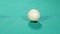 White billiard ball hit with a cue stick