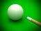 White billiard ball with stick on green pool table