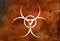 White biohazard sign over rust metal background