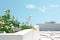 White bird sits on the balcony of a modern house with green plants, eco-friendly rooftop gardens. Blue sky in the background. The