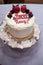 White Birthday Cake made with white frosting and Strawberries and blueberries and raspberries.