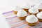 White birthday cupcakes on the striped linen napkin