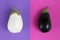 white and black eggplants isolated on fuchsia, and purple, background