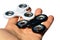 White and black fidget spinner toys held in palm of adult male person, white background