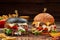 White and black hamburgers with veal patty on wooden table with fried potatoes