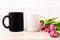 White and black mug mockup with magenta pink tulips bouquet