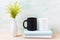 White and black mug mockup with ornamental green flowering grass