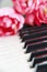 white and black piano keys and pink flowers