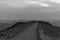 White and black sunrise in negev desert in israel. Mountain road to colorful horizon view