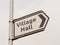 white and black village hall sign post direction street