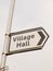 white and black village hall sign post direction street