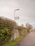 white and black village hall sign post direction street