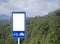 White blank of bike and bicycle route direction signs with mountaion and cloudy sky behind