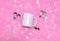 White blank coffee mug on the top of a fluffy pink carpet surrounded by tiny lovely decorations