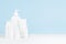White blank cosmetics bottles mockup on soft light blue background on table for hygiene, cleansing and body care, treatment.