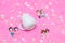 White blank milk mug on the top of a fluffy pink carpet surrounded by tiny lovely decorations