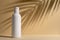 White blank packaging cosmetic bottle with shadow of palm leaves