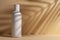 White blank packaging cosmetic bottle with shadow of palm leaves