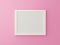 White blank photo frame isolated on pink background in gallery. 3d render illustration. Empty mock up clean sweet picture on