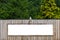 White blank rusty billboard or placard on a wooden wall in the nature. Store front