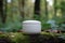 White and blank, unbranded cosmetic cream jar standing in the forest. Skin care product presentation. Skincare, beauty