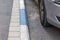 White and blue coloring of the curb on the road to indicate paid Parking in Israel