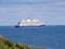 A white blue cruise ship sailing off the English coast near Falmouth