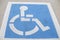 A white and blue handicap parking lot reservation spot