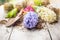 White and blue hyacinth with shovel and earth on garden white wooden table