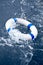 White and blue lifebelt, lifebuoy in ocean storm wave
